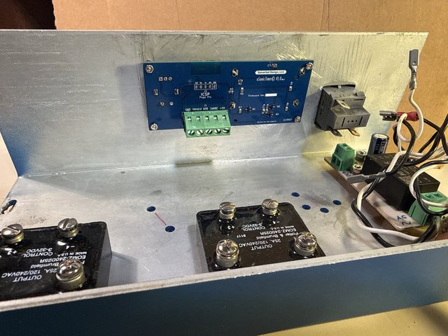 Inside the enclosure: the blue uSonicTimer V1.0 board from Somerled Design, LLC with its ICSP pogo pads and a green terminal block, two Potter and Brumfield 25 A solid-state relays on the floor, and the power entry module